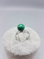 A MALACHITE SOLITAIRE RING with a green stone on it.
