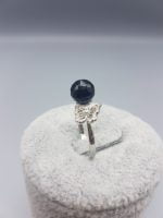 A BLACK ONYX AND BUTTERFLY RING with a black onyx stone.