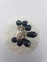 RING WITH BLACK ONYX CHARMS.