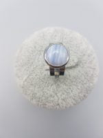 A light blue chalcedony ring with blue stone on top.