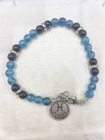 A bracelet with ANGELITE beads and black onyx and a FISH charm.