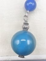 A KEYCHAIN WITH BLUE AGATE hanging from a silver chain.