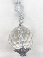 A KEYCHAIN WITH ROCK CRYSTAL OR HYALINE QUARTZ hanging from a silver chain.