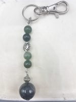 A keychain with green musky agate beads and a silver bead.