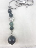 A KEYCHAIN WITH MUSKY AGATE with green and silver beads.