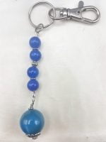 A blue agate keychain with a silver chain.
