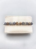 A MEN'S BRACELET WITH SODALITE AND TIGER'S EYE WITH LEATHER CORD with blue and silver beads.