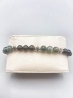 A MUSKY AGATE AND BLACK ONYX ELASTIC BRACELET with green and black beads.