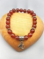 A red carnelian bracelet with Om pendant.