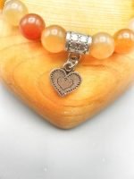 A RED AVENTURINE BRACELET WITH HEART with heart charm and orange agate.