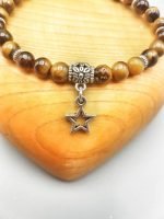 A bracelet with 6mm tiger's eye beads and a star pendant.