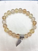 A citrine quartz bracelet with feather pendant.
