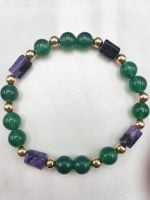A bracelet with green and purple beads.