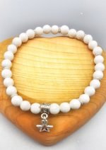 A 6MM WHITE AGATE BRACELET WITH STAR PENDANT with star charm.