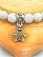 A 6 mm white agate bracelet with star pendant.