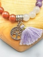 A BRACELET OF THE SEVEN CHAKRAS WITH PENDANT with tree of life pendant and tassel.