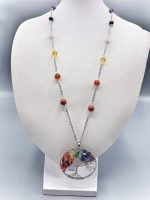 A necklace with TREE OF LIFE SEVEN CHAKRA NECKLACE on it.