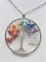 A TREE OF LIFE SEVEN CHAKRA NECKLACE necklace with stones of different colors.