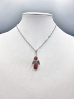 A CARNELIAN ANGEL PENDANT with silver chain.