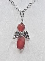A carnelian angel pendant with a red stone.