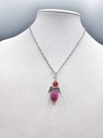 A necklace with a stone RUBY JADE ANGEL PENDANT.