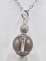 A spherical smoky quartz pendant with a gray sphere.