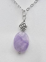 An oval amethyst pendant on a silver chain.