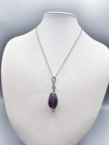 An amethyst and diamond necklace on a mannequin with PURPLE FLUORITE PENDANT.