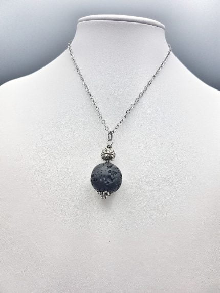 A lava stone pendant with a black stone.