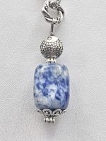 A necklace with a SODALITE BARREL PENDANT.