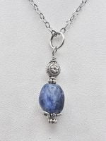 A silver necklace with a SODALITE PENDANT stone on it.