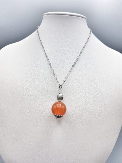 SPHERICAL CARNELIAN PENDANT is a necklace with orange and silver pearl.