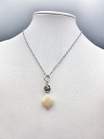 A necklace with a MOTHER OF PEARL PENDANT and a silver chain.