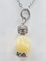 A yellow calcite pendant on a silver chain.