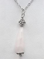 A rose quartz drop pendant on a silver chain.