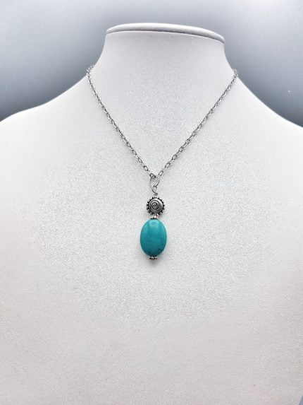 A necklace with a TURQUOISE and SILVER PENDANT.