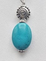 Turquoise pendant with spiral design.