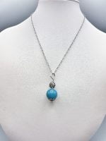 A pendant with a bead of blue agate sphere.
