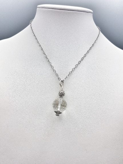 A mannequin shows a necklace with a pendant ROCK CRYSTAL PENDANT SPHERE.