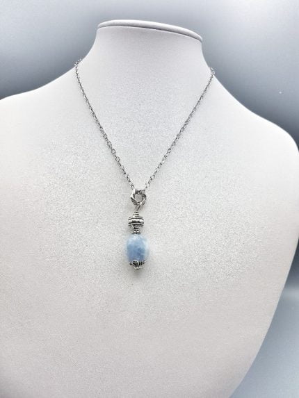 A necklace with blue jade pendant on mannequin CHALCEDONY BARREL PENDANT.