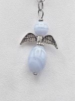 AN ANGEL CHALCEDONY PENDANT with wings on a silver chain.