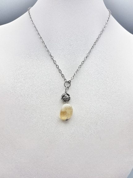 A necklace with a STONE CITRINE QUARTZ PENDANT and a silver chain.