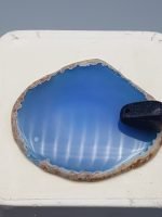 A piece of INCENSE BURNER SLICE OF BLUE AGATE on a white plate.