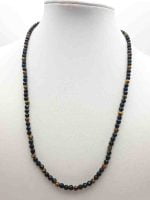 A MEN'S NECKLACE WITH BLACK ONYX AND TIGER'S EYE 4MM WITH black and yellow beads on mannequin.