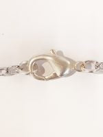 A silver chain with a clasp.