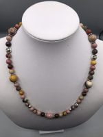 A RHODONITE AND MOOKAITE NECKLACE with pink, yellow and silver beads.