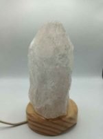 A Rock Crystal Lamp 2/3 kg on a wooden support.