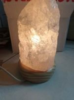 A 2/3 KG ROCK CRYSTAL LAMP WITH A QUARTZ STONE ON TOP.