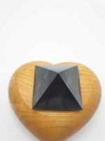 A SHUNGITE PYRAMID 4 CM in a heart-shaped box.