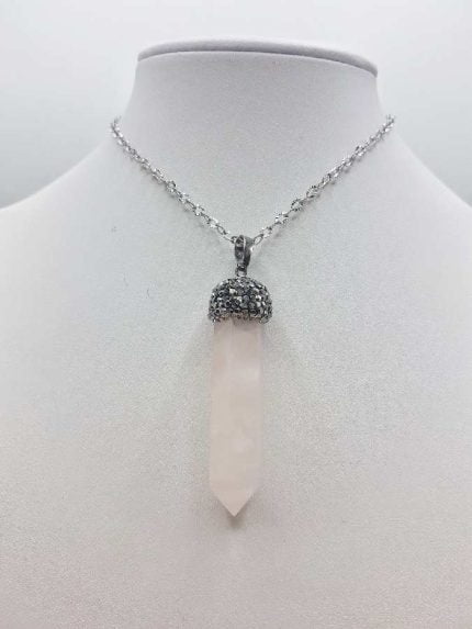 A ROSE QUARTZ SPIKE with a rose quartz stone and a silver chain.